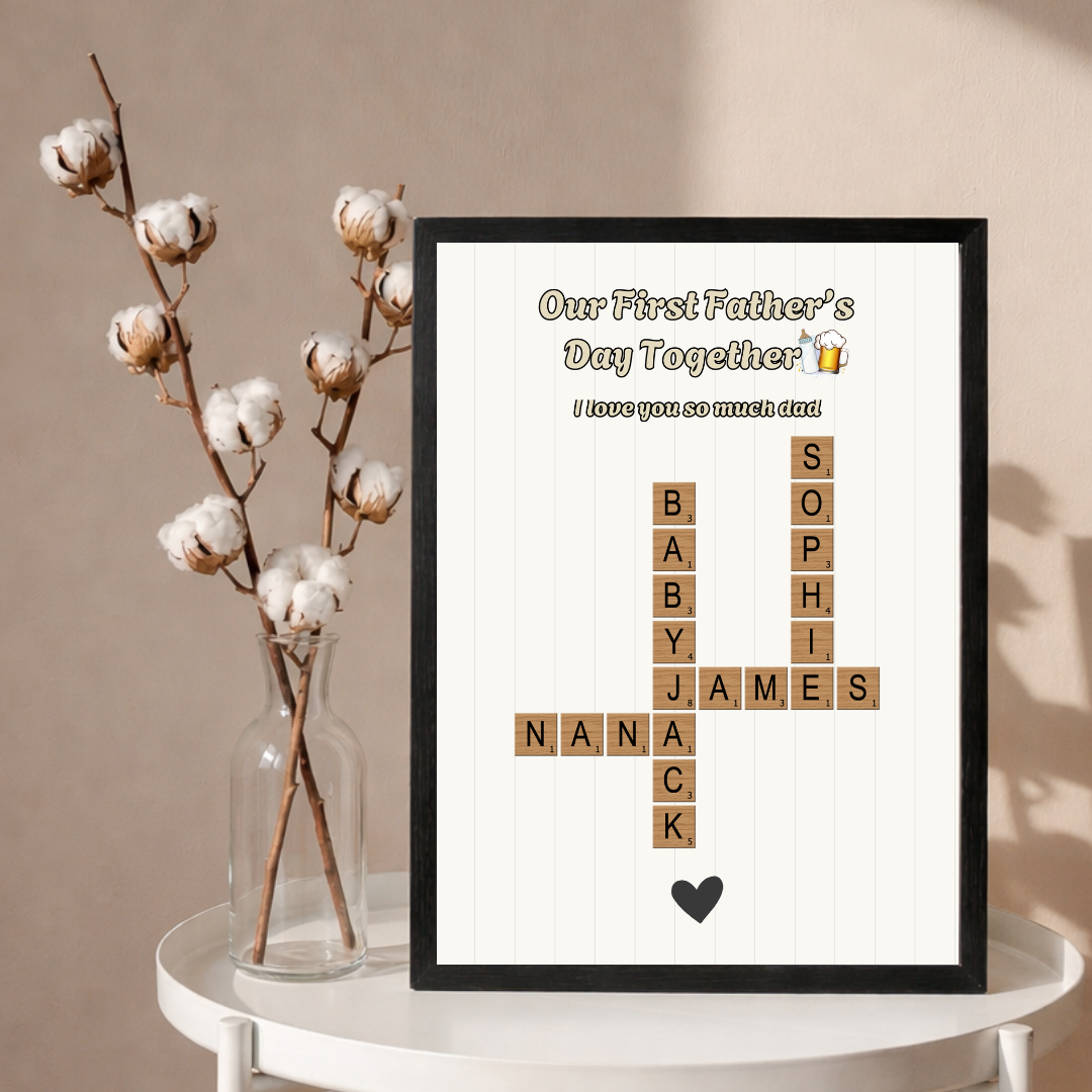 A framed first Father's Day print with family names in a Scrabble-tile crossword, titled 'Our First Father's Day Together'